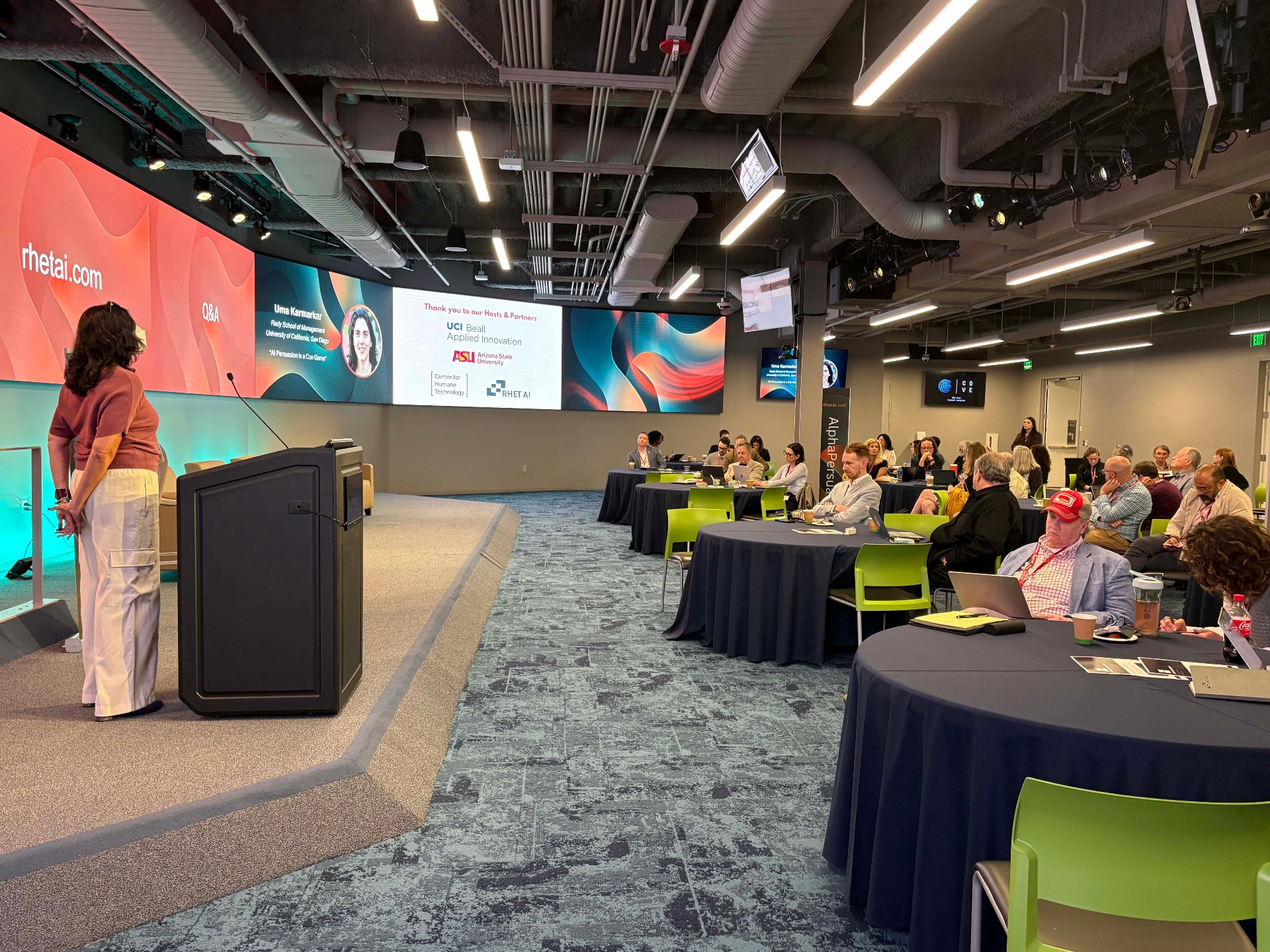 Uma Karmarkar speaking to the 2026 AlphaPersuade audience